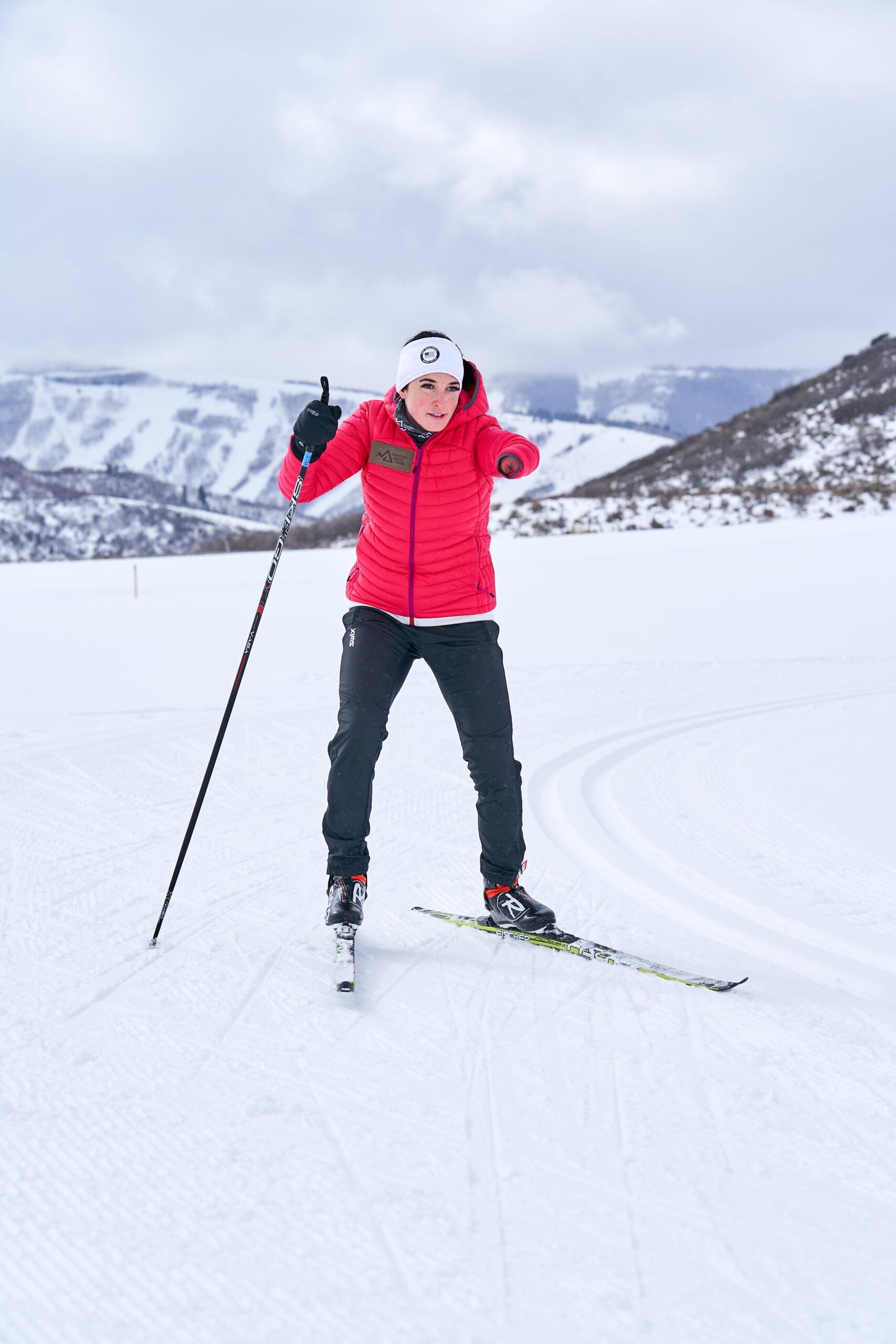 Woman adaptive skate skiing in pink jacket