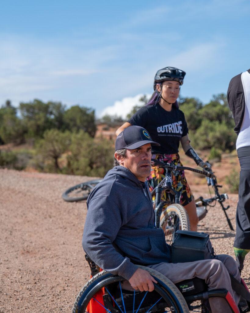 A person in a wheelchair looks out of frame. 